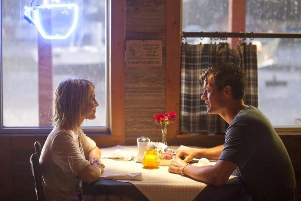 Julianne Hough (left) and Josh Duhamel star in a scene from “Safe Haven” that filmed in the Wildlife Restaurant and Grill in Southport. [20TH CENTURY FOX PHOTO] 