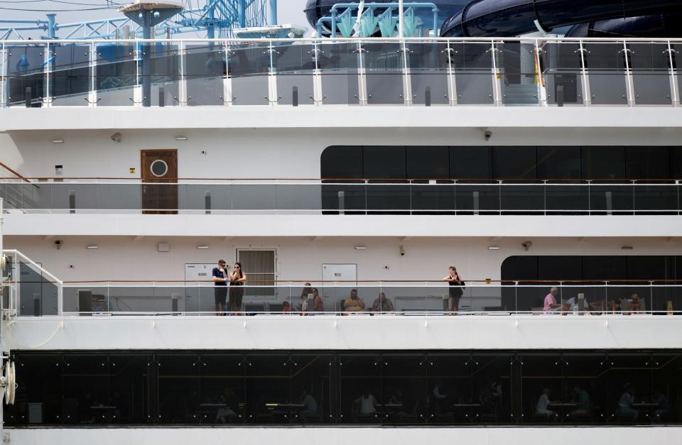 13 Tourists are seen at Cruise liner MSC Meraviglia, while berthed at a dock in Punta Langosta after two Caribbean ports denied the ship entry due to fears, later disproven, that a crew member was infected with the coronavirus, in Cozumel