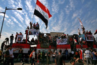 Anti-government protesters gather on the closed Joumhouriya Bridge that leads to the Green Zone government areas in Baghdad, Iraq, Sunday, Oct. 25, 2020. (AP Photo/Khalid Mohammed)