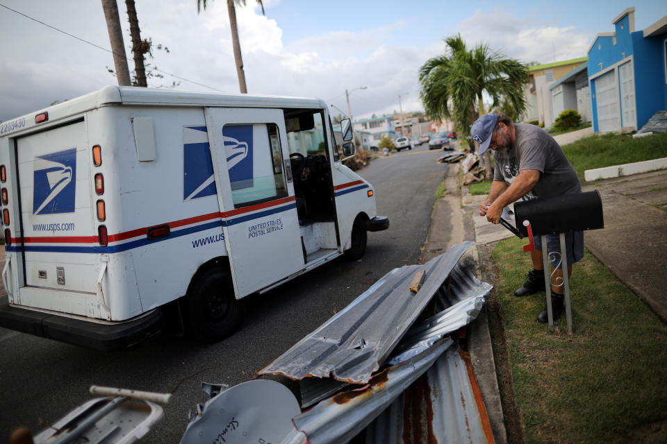 <p>Alfredo Martinez, a mail man for the U.S. Postal Service delivers the mail at an area damaged by Hurricane Maria in San Juan, Puerto Rico, Oct. 6, 2017. (Photo: Carlos Barria/Reuters) </p>