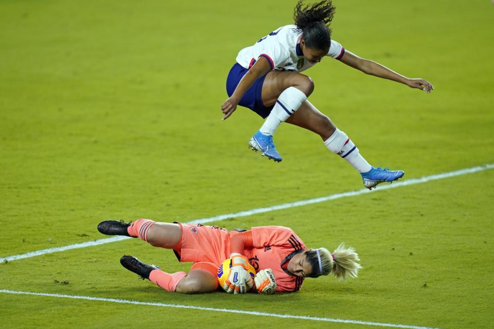 Colombia goalkeeper Sandra Sepulveda, bottom, makes a save as U.S. defender Margaret Purce leaps over her.