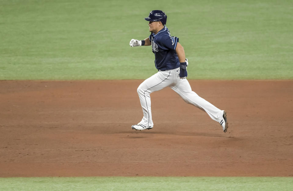Tampa Bay Rays' Yoshi Tsutsugo races toward third base on a double hit by Francisco Mejia during the fourth inning of a baseball game against the Oakland Athletics Tuesday, April 27, 2021, in St. Petersburg, Fla. (AP Photo/Steve Nesius)