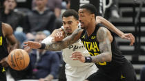 San Antonio Spurs center Victor Wembanyama, left, and Utah Jazz forward John Collins reach for ball during the first half of an NBA basketball game Wednesday, March 27, 2024, in Salt Lake City. (AP Photo/Rick Bowmer)