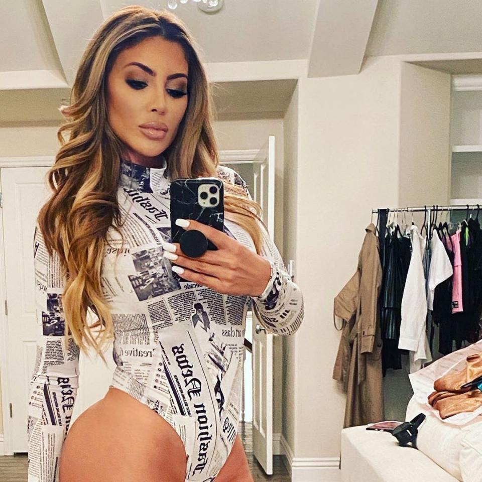 Larsa Pippen poses in a newspaper-print bodysuit