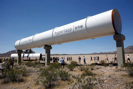 Journalists and guests look over tubes following a propulsion open-air test at Hyperloop One in North Las Vegas, Nevada, U.S. May 11, 2016. REUTERS/Steve Marcus