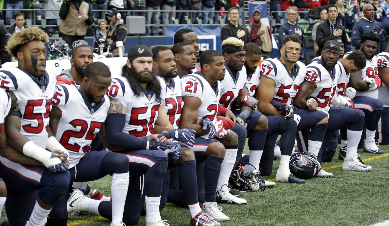 Texans players kneel during the singing of the national anthem before an October game in Seattle against the Seahawks. (AP)