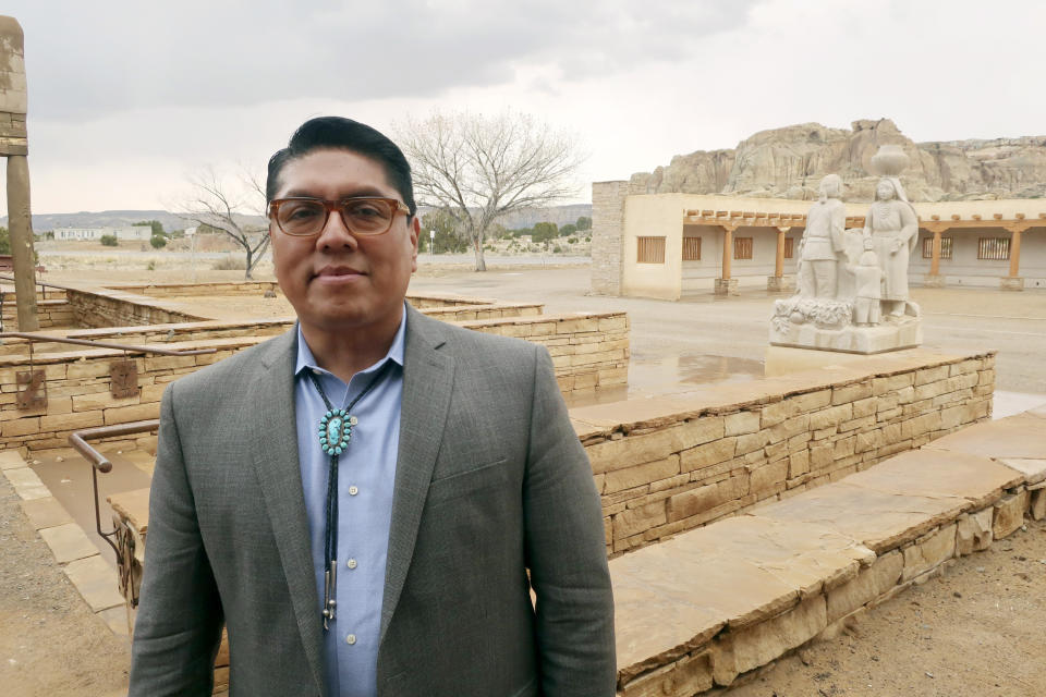 FILE - In this March 21, 2019 file photo, Acoma Pueblo Gov. Brian Vallo poses outside the Pueblo's cultural center about 60 miles west of Albuquerque, New Mexico. A ceremonial shield at the center of a yearslong international debate over exporting of sacred Native American objects to foreign markets has returned to New Mexico. U.S. and Acoma Pueblo officials planned Monday, Nov. 18 to announce the shield’s return from Paris, where it had been listed for bidding in 2016 before the EVE auction house took the rare step of halting its sale. “It will be a day of high emotion and thanksgiving,” Vallo said ahead of the shield’s expected return to his tribe. (AP Photo/Felicia Fonseca, File)