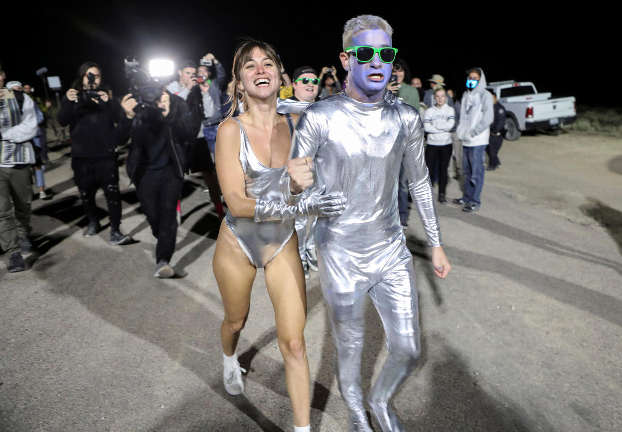 People dressed in costumes chant as they approach a gate to Area 51 as an influx of tourists responding to a call to 'storm' Area 51, a secretive U.S. military base believed by UFO enthusiasts to hold government secrets about extra-terrestrials, is expected in Rachel, Nevada, U.S. September 20, 2019. REUTERS/Jim Urquhart