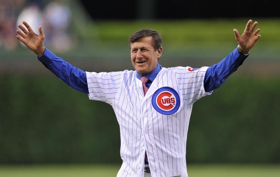 FILE - In this June 1, 2016, file photo, longtime NBA sideline reporter Craig Sager reacts after throwing out the ceremonial first pitch before a baseball game between the Chicago Cubs and the Los Angeles Dodgers at Wrigley Field in Chicago. Sager has died at the age of 65 after a battle with cancer. Turner President David Levy says in a statement Thursday, Dec. 15, 2016, that Sager had died, without saying when or where. (AP Photo/Paul Beaty, File)