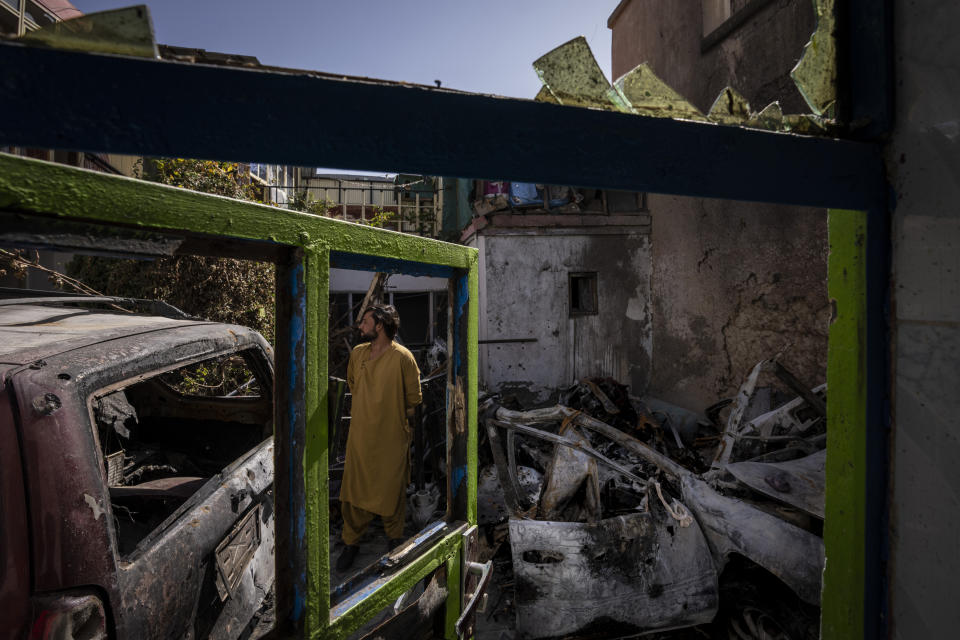 FILE - This Monday, Sept. 13, 2021 file photo, an Afghan inspects the damage of Ahmadi family house in Kabul, Afghanistan. Sorry is not enough for the Afghan survivors of an errant U.S. drone strike that killed 10 members of their family, including seven children. On Saturday, Sept. 18, they demanded Washington investigate who fired the drone and punish the military personnel responsible for the strike, said Emal Ahmadi, whose 3-year-old daughter Malika was killed on Aug. 29 when the U.S. hellfire missile struck his elder brother's car. (AP Photo/Bernat Armangue, File)