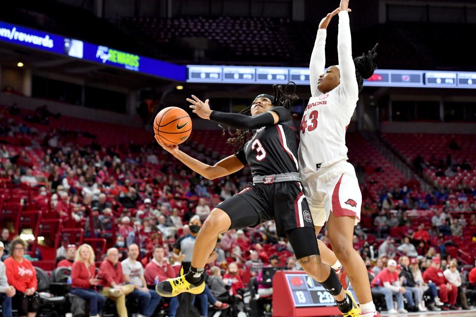 South Carolina guard Destanni Henderson (3) drives past Arkansas guard Makayla Daniels (43) to score during the first half of an NCAA college basketball game Sunday, Jan. 16, 2022, in Fayetteville, Ark. (AP Photo/Michael Woods)