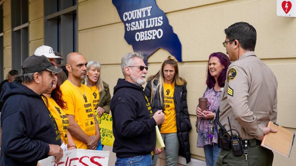 California Homeless Union lawyer Anthony Prince, center, and union members held a demonstration and news conference Tuesday afternoon, Jan. 23, 2024, at the Katcho Achadjian Government Center to announce the filing of lawsuit over the management of the Oklahoma Avenue Safe Parking Site.