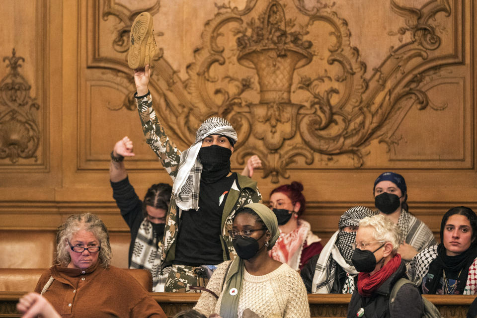 People react to public comment at the San Francisco Board of Supervisors meeting in San Francisco, Monday, Jan. 8, 2024. The city's board of supervisors took up a controversial resolution calling for a sustained cease-fire in Gaza, a resolution that pro-Palestinian and Jewish peace groups have successfully pushed through in other cities. (AP Photo/Nic Coury)