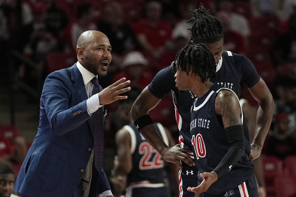 Jackson State head coach Mo Williams talks with his players during the first half of an NCAA college basketball game against Houston, Saturday, Dec. 9, 2023, in Houston. (AP Photo/Kevin M. Cox)