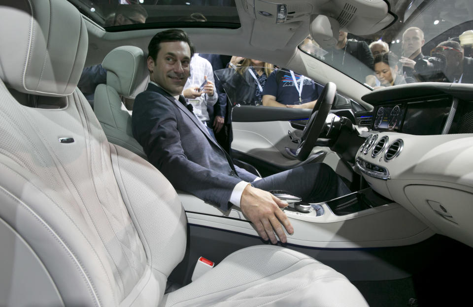 Actor Jon Hamm, of television's "Mad Men," sits in the 2015 Mercedes Benz S63 AMG Coupe, during its introduction at the 2014 New York International Auto Show at the Javits Convention Center, Wednesday, April 16, 2014, in New York. (AP Photo/Richard Drew)