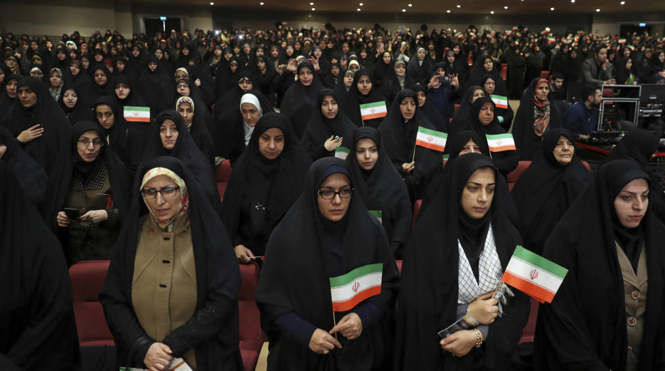 Female members of the the Basij paramilitary force affiliated to the Iran's Revolutionary Guard stand at attention for the national anthem in one of the ceremonies marking "Basij Week" and also commemorating the 40th anniversary of establishment of the force, in Tehran, Iran, Sunday, Nov. 24, 2019. (AP Photo/Vahid Salemi)