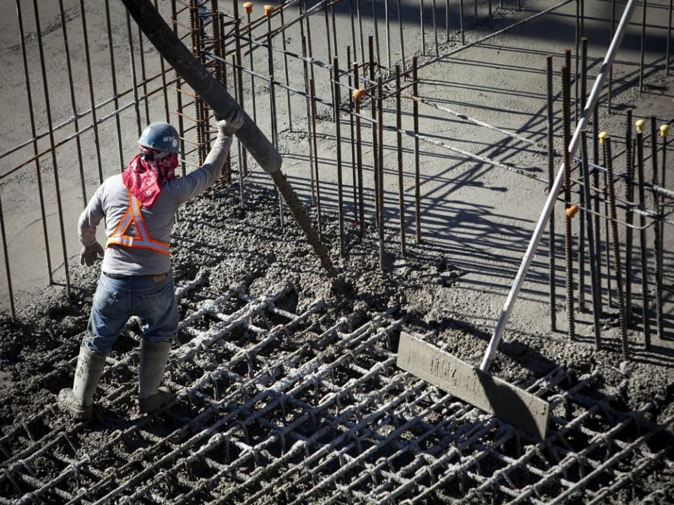  A contractor pours cement into the base of a condominium under construction in downtown Vancouver.