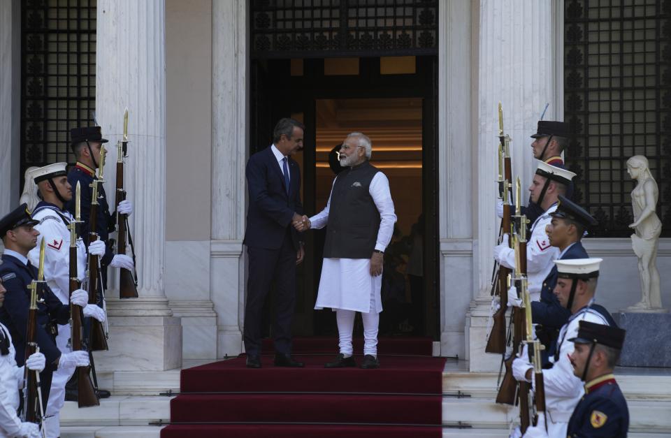 Greece's Prime Minister Kyriakos Mitsotakis, left, welcomes his Indian counterpart Narendra Modi at Maximos Mansion in Athens, Greece, Friday, Aug. 25, 2023. Modi's visit to Athens is especially significant for Greek foreign policy as it is the first official visit by an Indian prime minister to Greece in 40 years. (AP Photo/Thanassis Stavrakis)