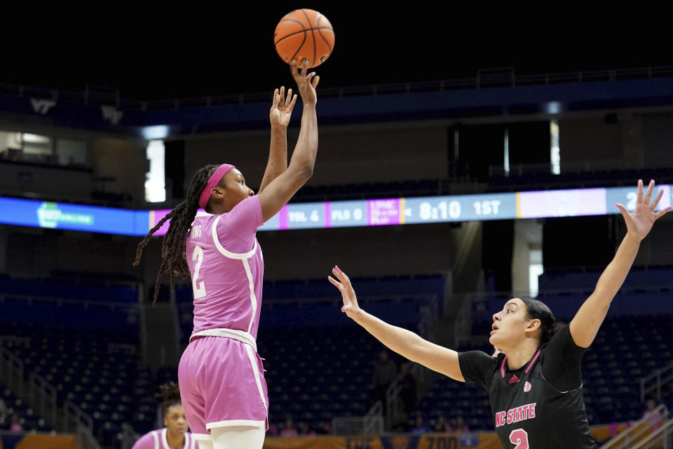 Pittsburgh forward Liatu King (2) puts up a shot over North Carolina State forward Mimi Collins (2) during the first half of an NCAA college basketball game Sunday, Feb. 11, 2024, in Pittsburgh. (AP Photo/Matt Freed)