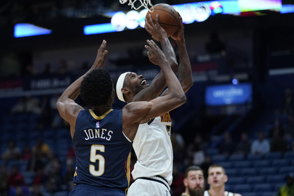 Denver Nuggets forward Will Barton goes to the basket against New Orleans Pelicans forward Herbert Jones (5) in the first half of an NBA basketball game in New Orleans, Wednesday, Dec. 8, 2021. (AP Photo/Gerald Herbert)