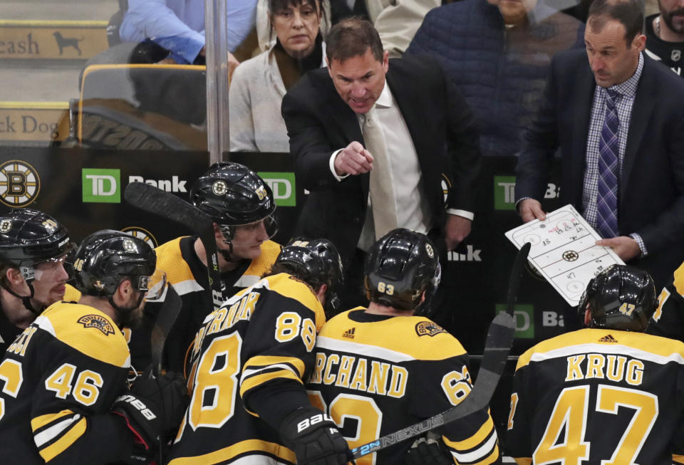 FILE - In this April 11, 2019, file photo, Boston Bruins coach Bruce Cassidy gestures to his players during the third period of Game 1 of an NHL hockey first-round playoff series against the Toronto Maple Leafs in Boston. Two roads diverged in a crazy world of hockey and brought them to this Stanley Cup Final. Cassidy has guided the Boston Bruins to this point a decade and a half after a disastrous tenure in Washington, and Berube took the St. Louis Blues from worst to their first final since 1970 several years after a short stint in Philadelphia. (AP Photo/Charles Krupa, File)