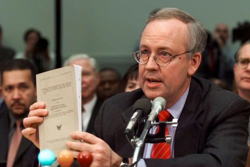 FILE - Independent Counsel Kenneth Starr holds a copy of his report while testifying on Capitol Hill Thursday Nov. 19, 1998, before the House Judiciary Committee's impeachment hearing. Starr, whose criminal investigation of Bill Clinton led to the president’s impeachment, died Sept. 13, 2022. He was 76.  (AP Photo/Doug Mills, File) ORG XMIT: WX122