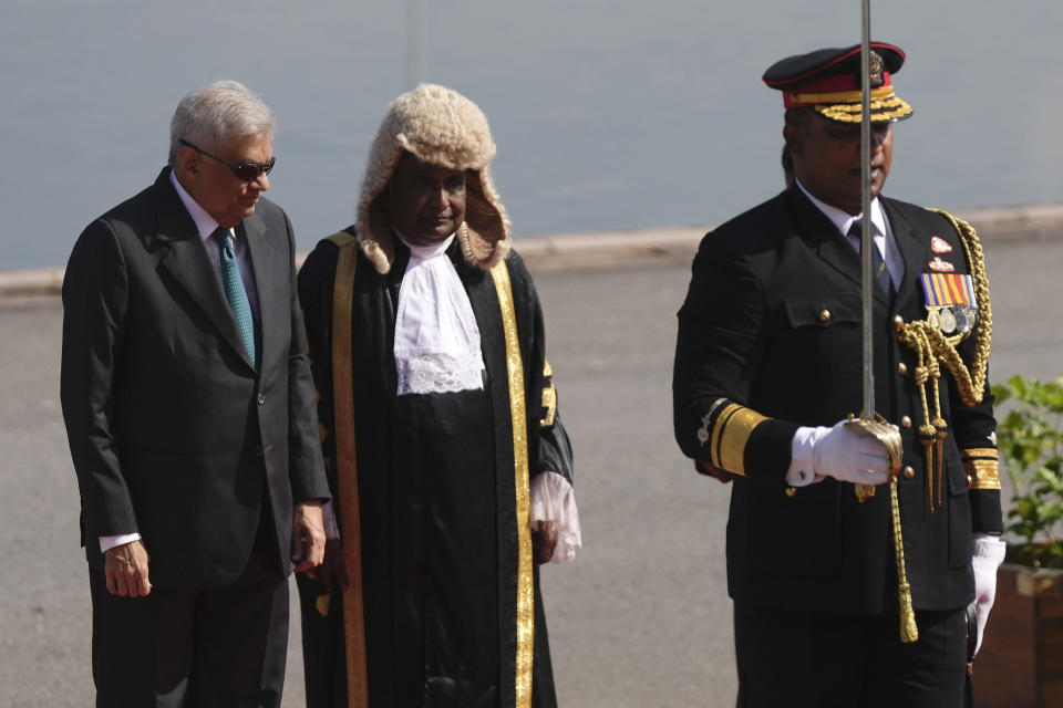 Sri Lankan president Ranil Wickremesinghe, left, arrives at the parliament to deliver his policy speech in Colombo, Sri Lanka, Wednesday, Feb. 8, 2023. Wickremesinghe on Wednesday appealed for patience amid the country's worst economic crisis but promised brighter times ahead. In the center is Sri Lankan parliament speaker Mahinda Yapa Abeywardena. (AP Photo/Eranga Jayawardena)