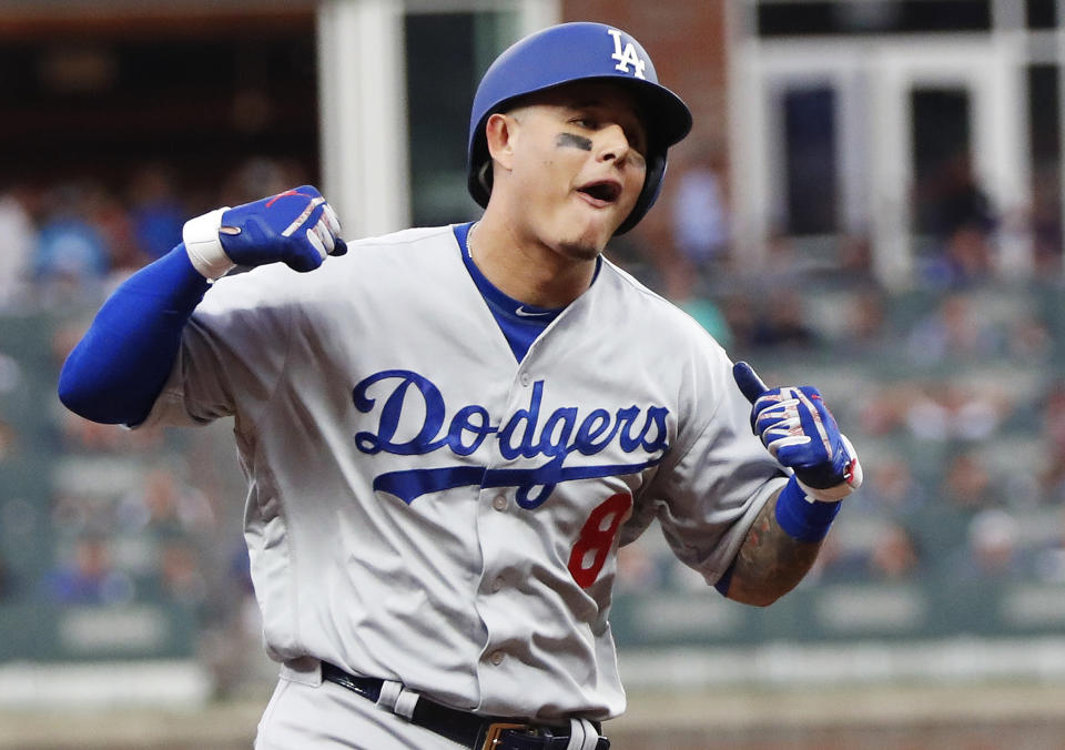 Los Angeles Dodgers' Manny Machado (8) celebrates his three-run homer against the Atlanta Braves during the seventh inning in Game 4 of baseball's National League Division Series, Monday, Oct. 8, 2018, in Atlanta. (AP Photo/John Bazemore)