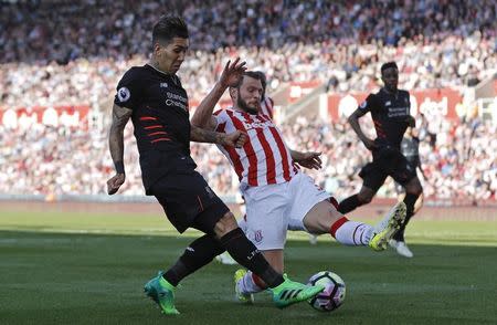 Britain Football Soccer - Stoke City v Liverpool - Premier League - bet365 Stadium - 8/4/17 Liverpool's Roberto Firmino in action with Stoke City's Erik Pieters Reuters / Darren Staples Livepic EDITORIAL USE ONLY. No use with unauthorized audio, video, data, fixture lists, club/league logos or "live" services. Online in-match use limited to 45 images, no video emulation. No use in betting, games or single club/league/player publications. Please contact your account representative for further details. - RTX34PT4