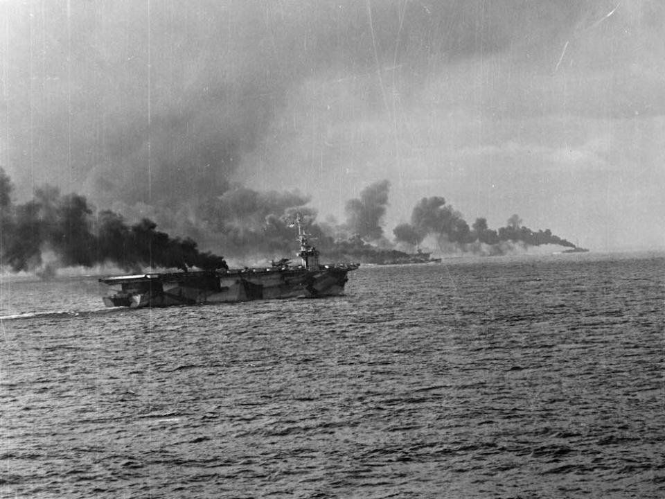 Battle of Leyte Gulf, Battle off Samar, October 25, 1944. USS Gambier Bay (CVE 73) and another escort carrier, and two destroyer escorts making smoke.