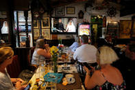 British tourists watch Britain's Prince Harry and Meghan Markle during their wedding, on a television in a restaurant in the British overseas territory of Gibraltar, historically claimed by Spain May 19, 2018. REUTERS/Jon Nazca