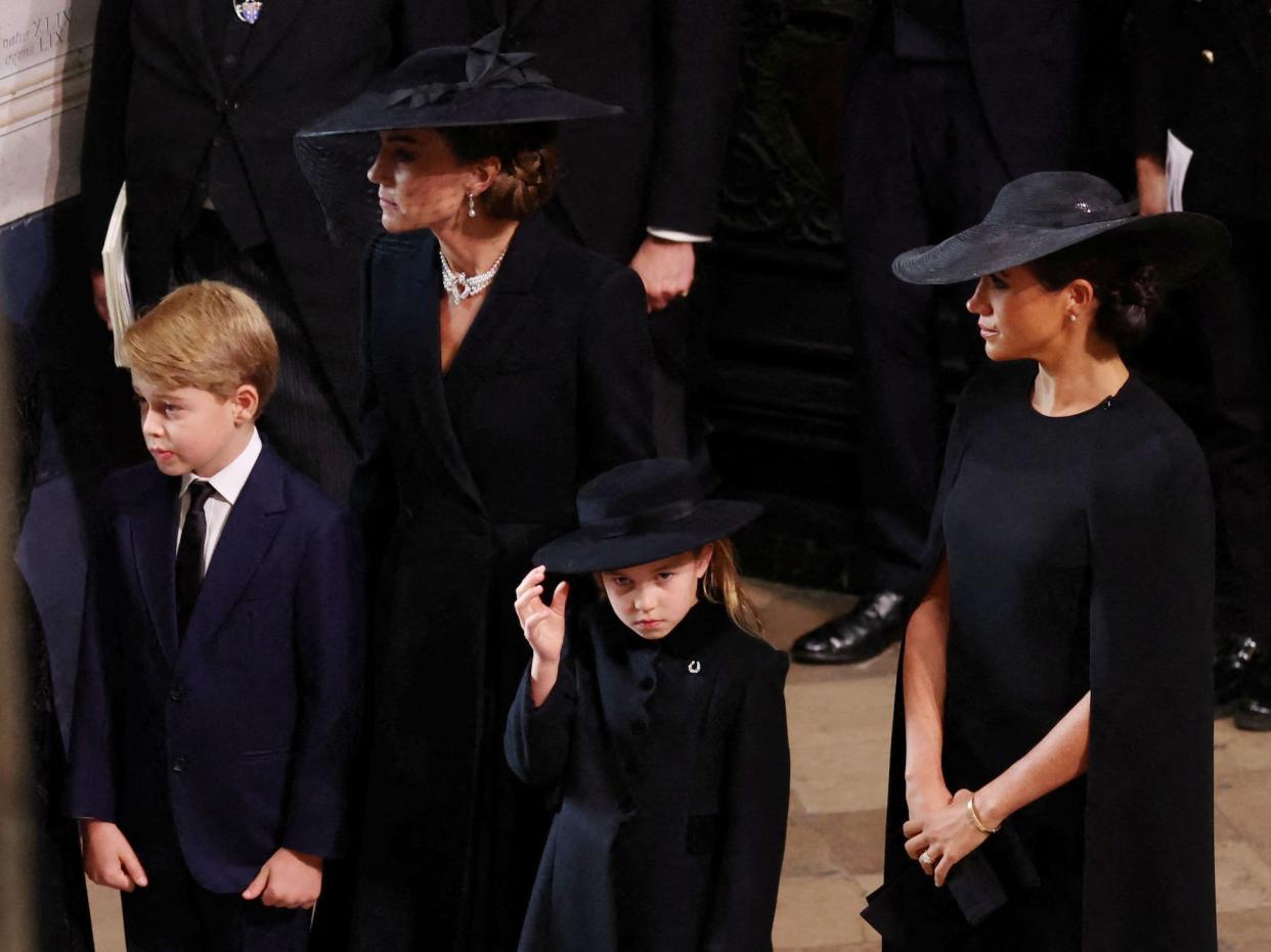 Kate Middleton, Meghan Markle, Prince George, and Princess Charlotte at Queen Elizabeht II's funeral.