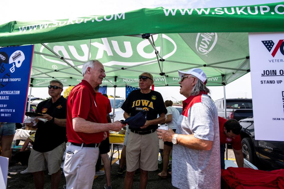 GOP presidential candidate Asa Hutchinson, left, talks with Sukup Manufacturing CEO Steve Sukup, right, at a tailgate before the Cy-Hawk football game at Jack Trice Stadium on Saturday, September 9, 2023 in Ames.