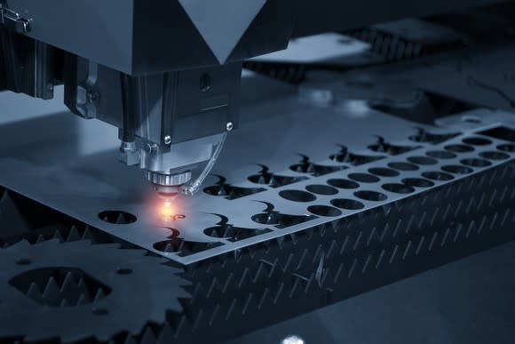 Laser system cutting shapes out of metal