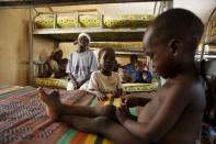 Cicilia Abel (2nd L), from the local government of Michika, rests with her children at the Malkohi camp for the Internally Displaced People after being rescued from Boko Haram in Sambisa forest, in Yola, Adamawa State, Nigeria, May 3, 2015. REUTERS/Afolabi Sotunde