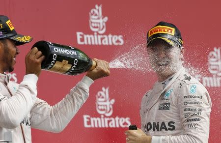 Britain Formula One - F1 - British Grand Prix 2016 - Silverstone, England - 10/7/16 Mercedes' Lewis Hamilton celebrates on the podium after winning the race with second placed Nico Rosberg REUTERS/Andrew Boyers Livepic EDITORIAL USE ONLY.