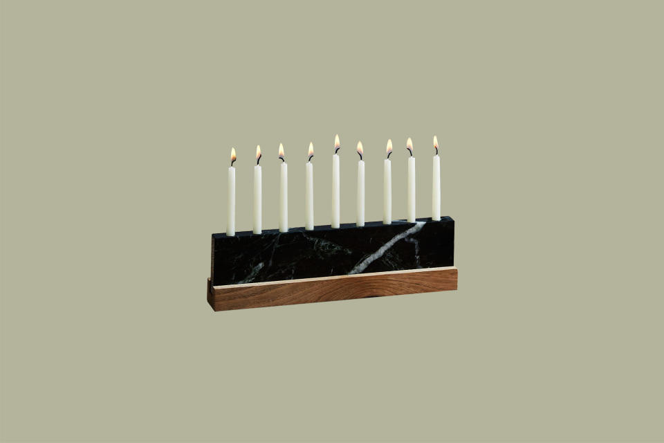 <p>Nothing looks more stately at the table than this menorah made from a slab of veined Vermont green marble and silky walnut. JK Adams is well known for their charming home goods, and this handcrafted piece from the family-owned business in Vermont is designed with a sliding wood base to secure nine standard menorah candles.</p><p><em>JK Adams Vermont Green Marble & Walnut Menorah, $68, </em><a href="http://www.anrdoezrs.net/links/9104911/type/dlg/sid/MMSLHOLModernMenorahsCBiggsOct19/https://food52.com/shop/products/5293-vermont-green-marble-walnut-menorah" rel="nofollow noopener" target="_blank" data-ylk="slk:food52.com;elm:context_link;itc:0;sec:content-canvas" class="link "><em>food52.com</em></a><em>.</em></p>