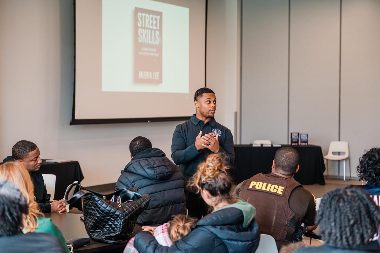 Officer Jalen Lee talks about his book “Street Skills: a guide to master interactions with the police" with a group of police and residents on Feb. 11, 2024, at Howard Park in South Bend.