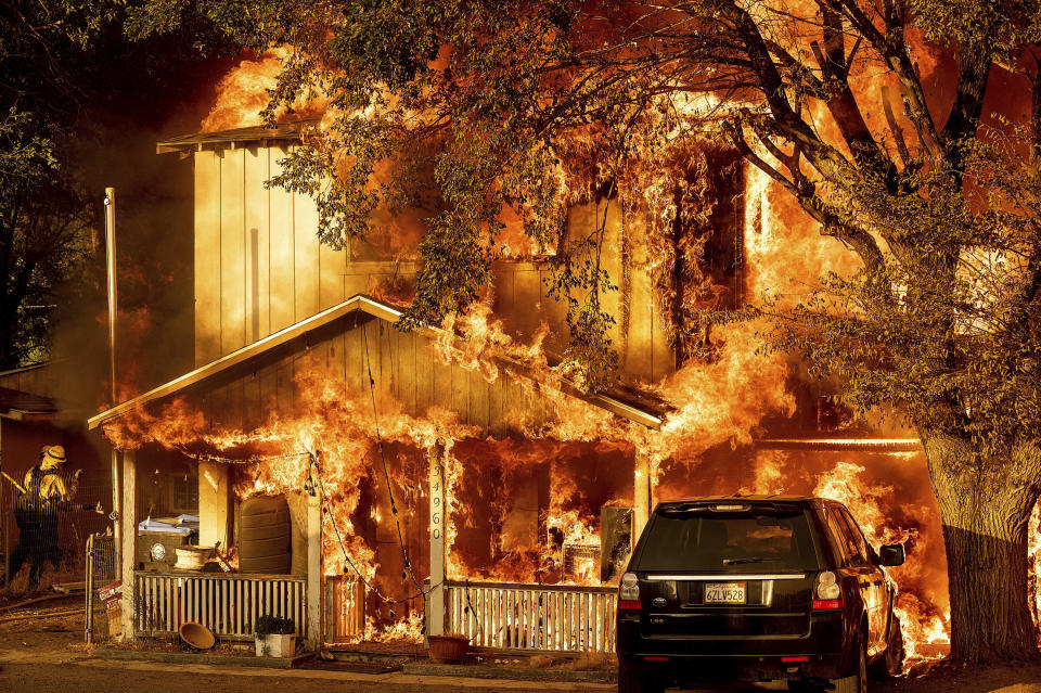 Fire consumes a home as the Sugar Fire, part of the Beckwourth Complex Fire, tears through Doyle, Calif., on Saturday, July 10, 2021. Pushed by heavy winds, the fire came out of the hills and destroyed multiple residences in central Doyle. (AP Photo/Noah Berger)