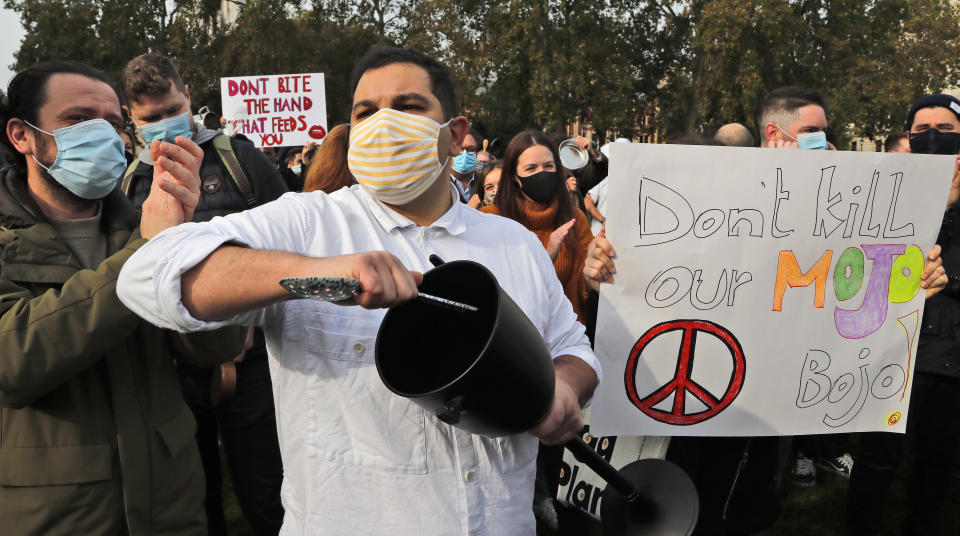 Hospitality workers protest in Parliament Square in London, Monday, Oct. 19, 2020. Hospitality workers are demonstrating outside Parliament against tougher coronavirus restrictions and the amount of financial support given by the government to the industry.(AP Photo/Frank Augstein)