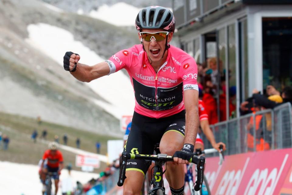Pink jersey Britains rider of team MitcheltonScott Simon Yates celebrates as he crosses the finish line to win the 9th stage between Pesco Sannita and the Gran Sasso during the 101st Giro dItalia Tour of Italy cycling race on May 13 2018  Mitchelton rider Yates crossed just ahead of Frances Thibaut Pinto and Colombian Esteban Chaves on the finished line at 2135 metres altitude The race included a gruelling 265km final climb to Campo Imperatore where Benito Mussolini was imprisoned in 1943 Photo by Luk Benies  AFP        Photo credit should read LUK BENIESAFP via Getty Images