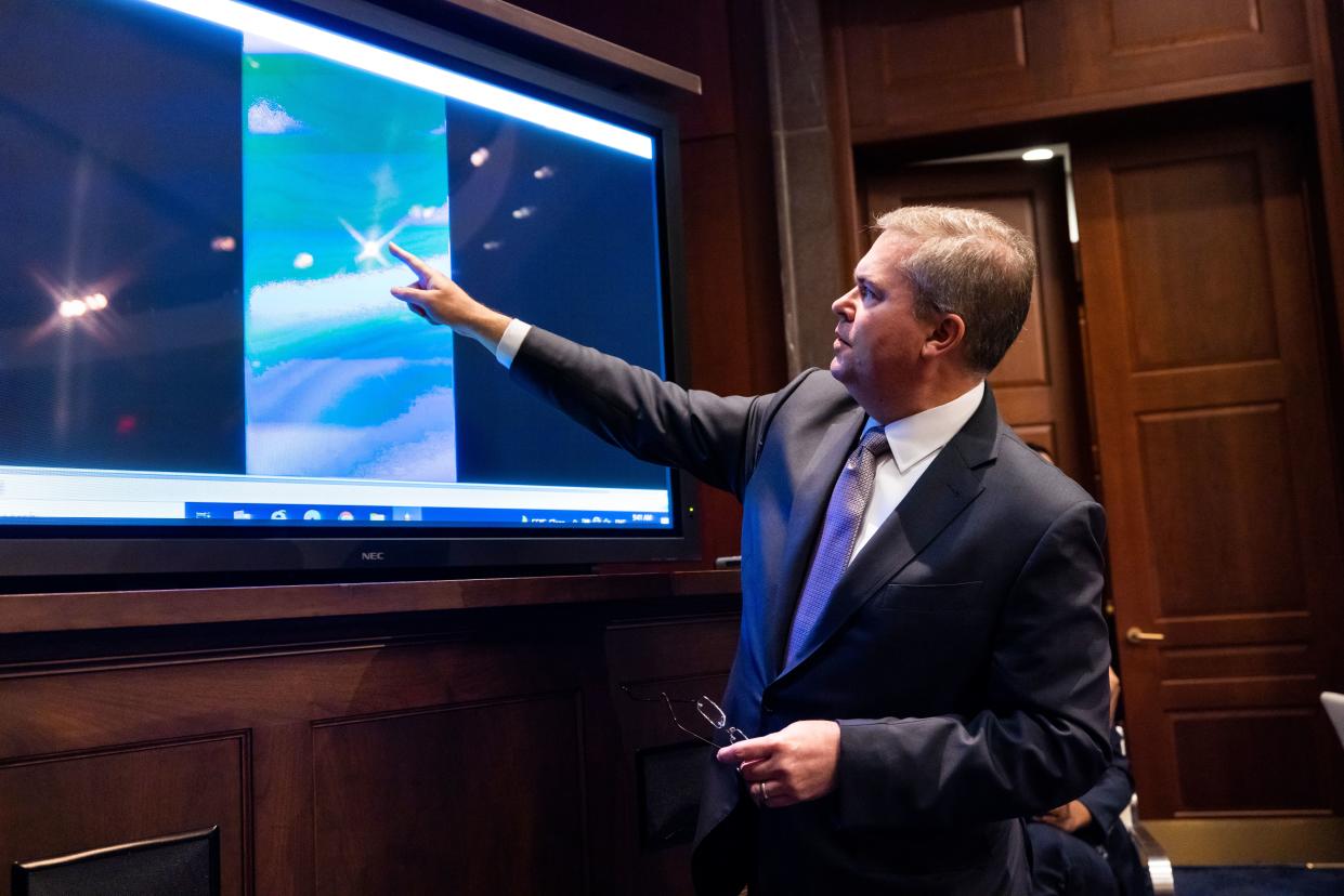 Deputy Director of Naval Intelligence Scott Bray plays a video of unidentified aerial phenomena, commonly referred to as UFOs, during a hearing.