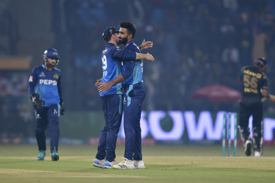 Multan Sultans' Usama Mir, center, celebrates with teammate after taking the wicket of Peshawar Zalmi' Babar Azam, right, during the Pakistan Super League T20 cricket match between Multan Sultans and Peshawar Zalmi, in Multan, Pakistan Friday, Feb. 23, 2024. (AP Photo/M. Khan)