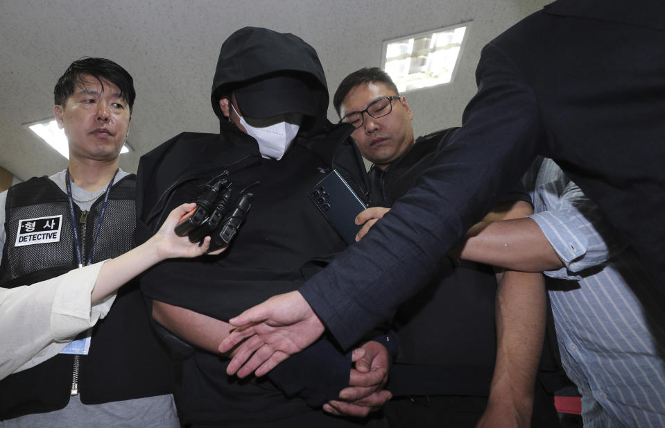 A man who opened an emergency exit door during a flight, arrives to attend an arrest warrant review at the Daegu District Court in Daegu, South Korea, Sunday, May 28, 2023. He told police that he felt suffocated and tried to get off the plane quickly as it approached landing, reports said Saturday. (Yun Kwan-shick/Yonhap via AP)