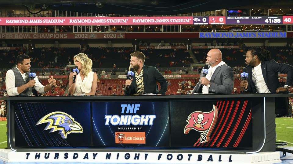 The Thursday Night Football crew, from left, Tony Gonzalez, Charissa Thompson, Ryan Fitzpatrick, Andrew Whitworth, and Richard Sherman, are shown before an NFL football game between the Baltimore Ravens and Tampa Bay Buccaneers Thursday, Oct. 27, 2022, in Tampa, Fla. (AP Photo/Jason Behnken)