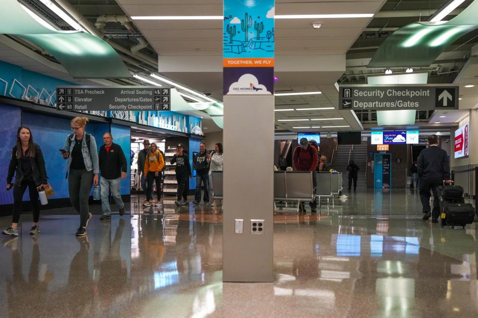 Travelers walk through the terminal at Des Moines International Airport.