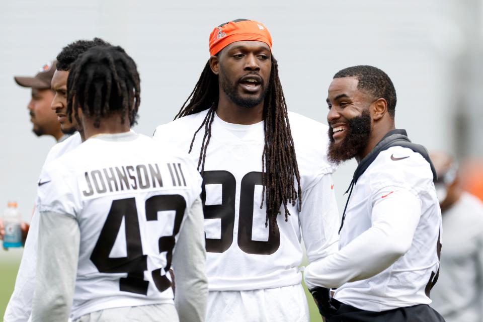 Cleveland Browns' Jadeveon Clowney (90) talks with John Johnson III (43) and Anthony Walker Jr. during an NFL football practice at the team's training facility Wednesday, May 25, 2022, in Berea, Ohio. (AP Photo/Ron Schwane)