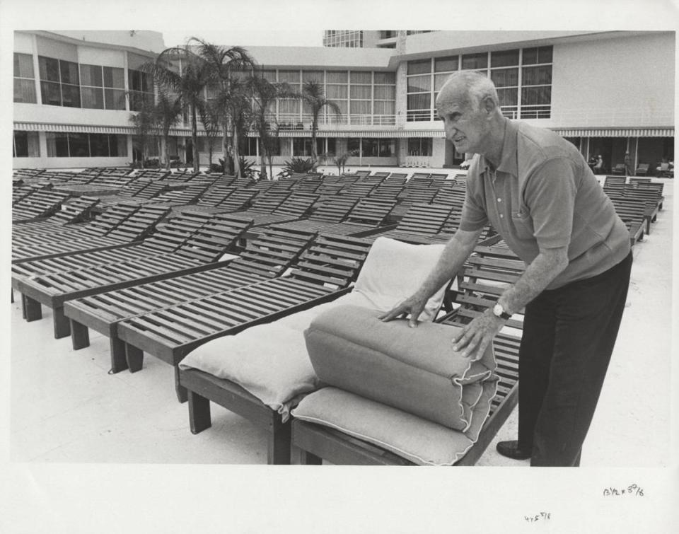 John Fazio, the pool and cabana manager at the Deauville Hotel, folds up a pad on a lounge chair by the hotel pool in July 1984.