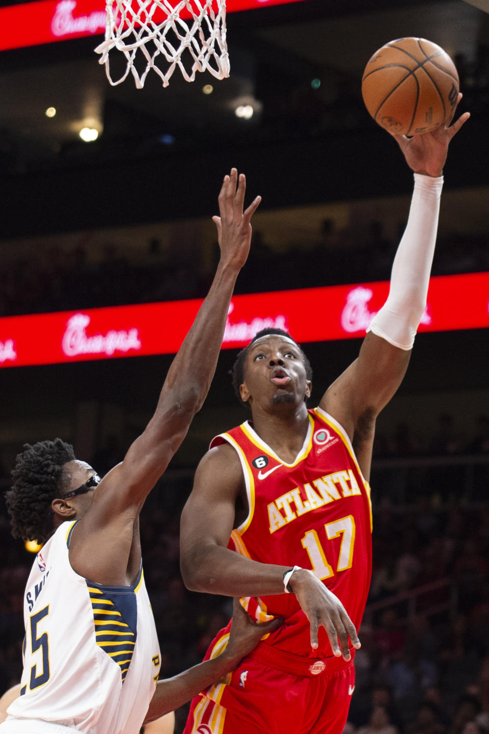 Atlanta Hawks forward Onyeka Okongwu scores over Indiana Pacers forward Jalen Smith during the first half of an NBA basketball game, Saturday, March 25, 2023, in Atlanta. (AP Photo/Hakim Wright Sr.)