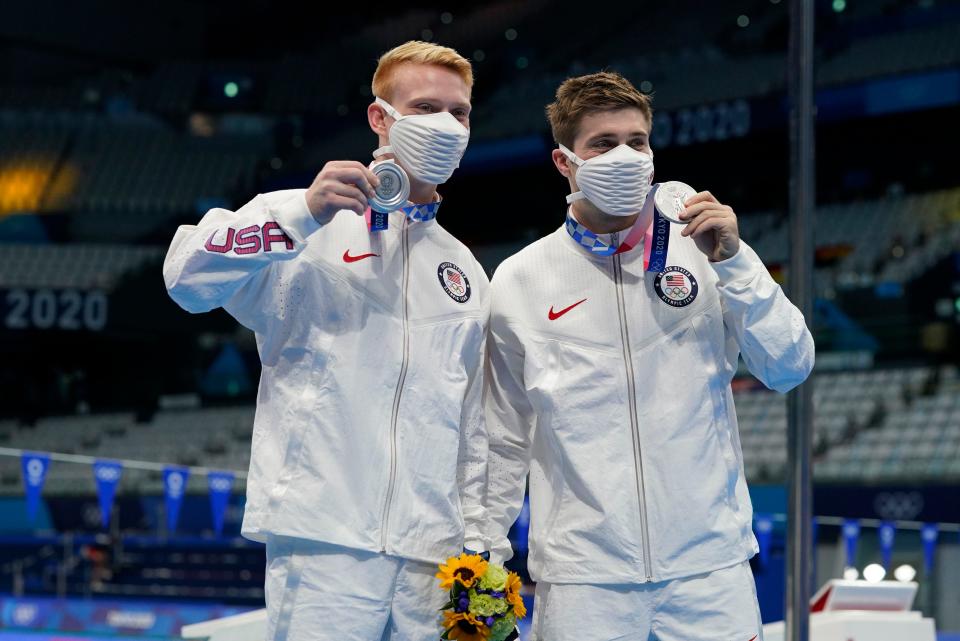 July 28: Andrew Capobianco and Michael Hixon pose with their silver medals after the men's 3-meter springboard synchronized diving competition.